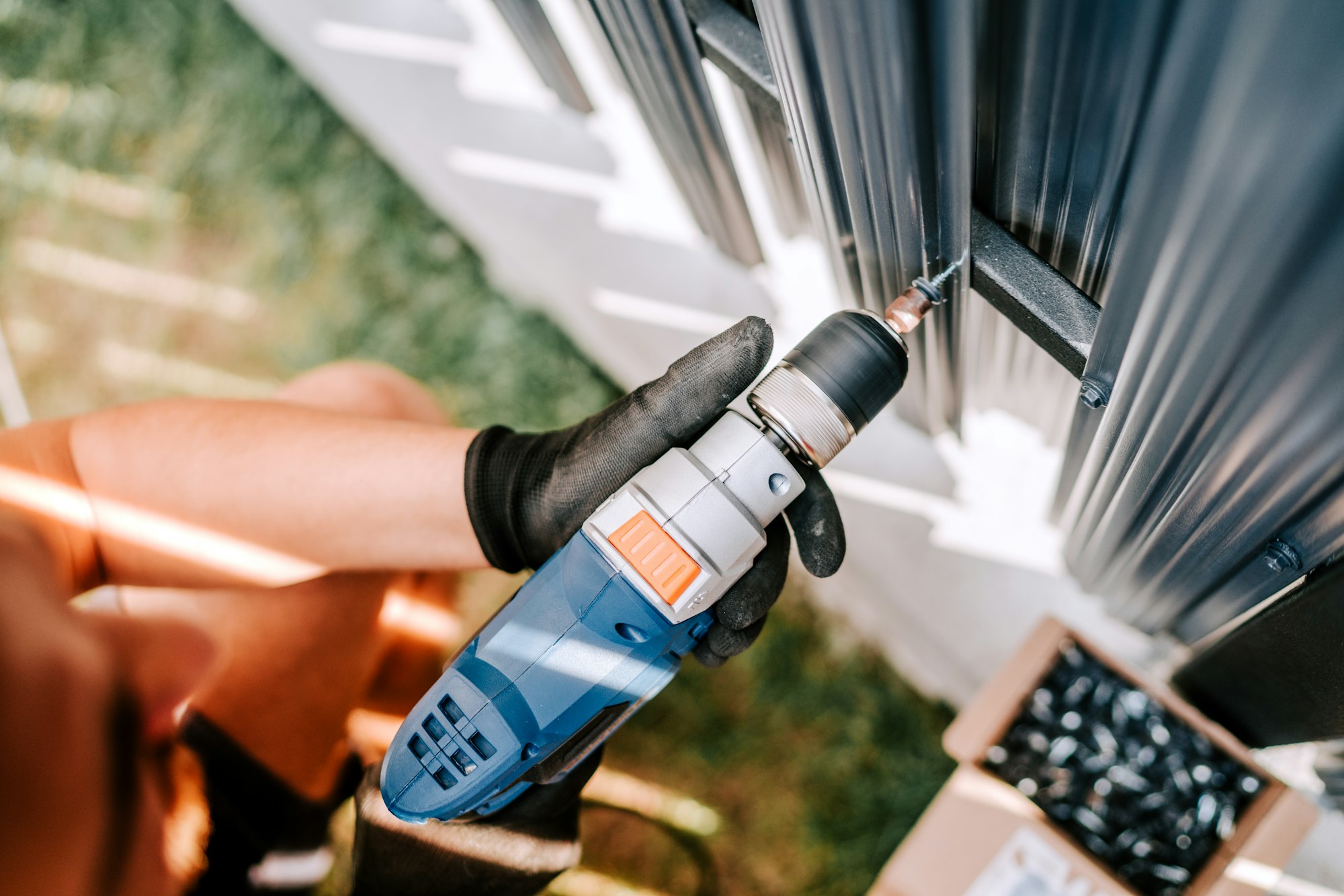 construction worker working with an electric screwdriver on the construction site